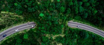 Aerial view of green bridge corridor for wildlife to cross highway safely.